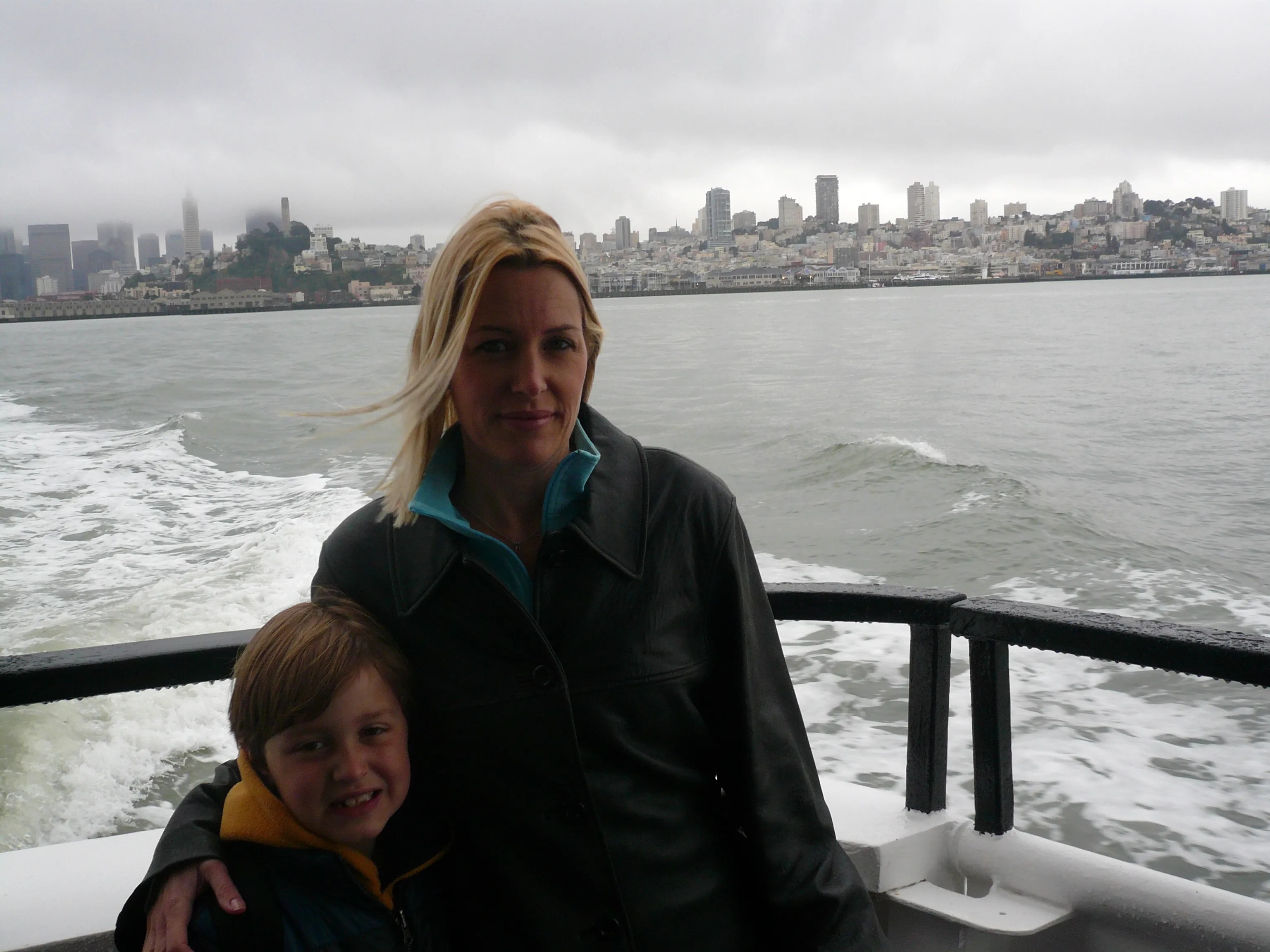 Alex with his mom on a ferry in 2009, San Francisco in background